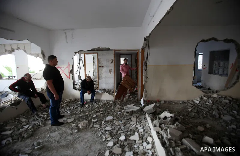 Palestinians check the house of Amjad Aliwi, a man accused of taking part in the killing of a Jewish settler couple near the settlement of Itamar in October last year, after Israeli authorities demolished it on October 1...