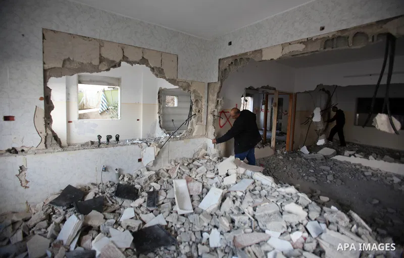 Palestinians check the house of Amjad Aliwi, a man accused of taking part in the killing of a Jewish settler couple near the settlement of Itamar in October last year, after Israeli authorities demolished it on October 1...