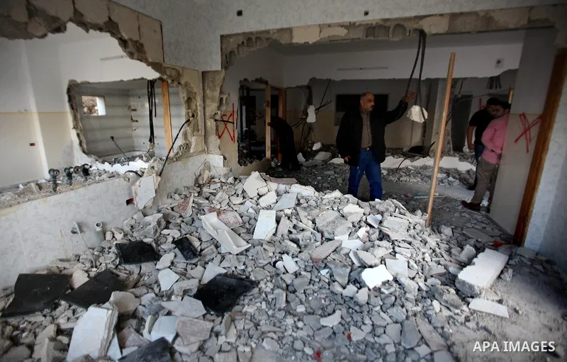Palestinians check the house of Amjad Aliwi, a man accused of taking part in the killing of a Jewish settler couple near the settlement of Itamar in October last year, after Israeli authorities demolished it on October 1...