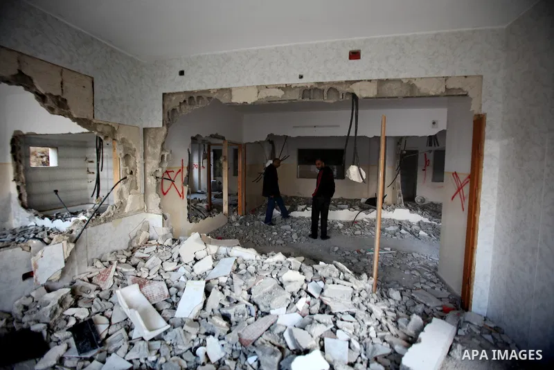 Palestinians check the house of Amjad Aliwi, a man accused of taking part in the killing of a Jewish settler couple near the settlement of Itamar in October last year, after Israeli authorities demolished it on October 1...