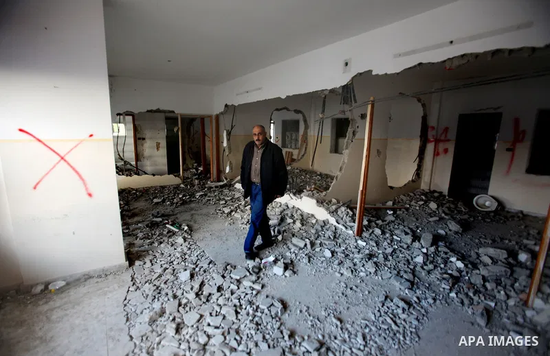 Palestinians check the house of Amjad Aliwi, a man accused of taking part in the killing of a Jewish settler couple near the settlement of Itamar in October last year, after Israeli authorities demolished it on October 1...
