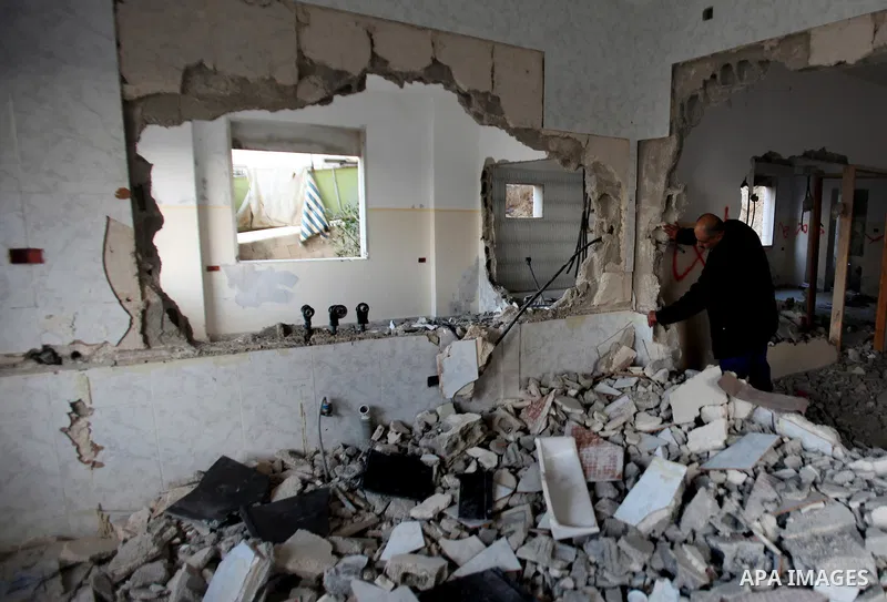 Palestinians check the house of Amjad Aliwi, a man accused of taking part in the killing of a Jewish settler couple near the settlement of Itamar in October last year, after Israeli authorities demolished it on October 1...