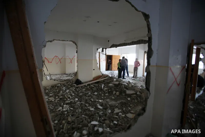 Palestinians check the house of Amjad Aliwi, a man accused of taking part in the killing of a Jewish settler couple near the settlement of Itamar in October last year, after Israeli authorities demolished it on October 1...