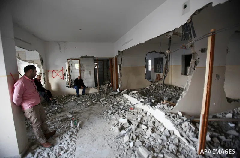 Palestinians check the house of Amjad Aliwi, a man accused of taking part in the killing of a Jewish settler couple near the settlement of Itamar in October last year, after Israeli authorities demolished it on October 1...
