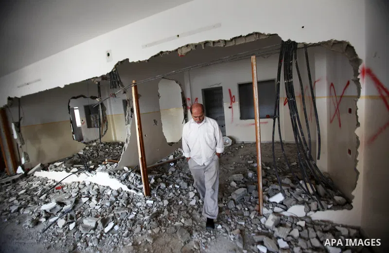 Palestinians check the house of Amjad Aliwi, a man accused of taking part in the killing of a Jewish settler couple near the settlement of Itamar in October last year, after Israeli authorities demolished it on October 1...