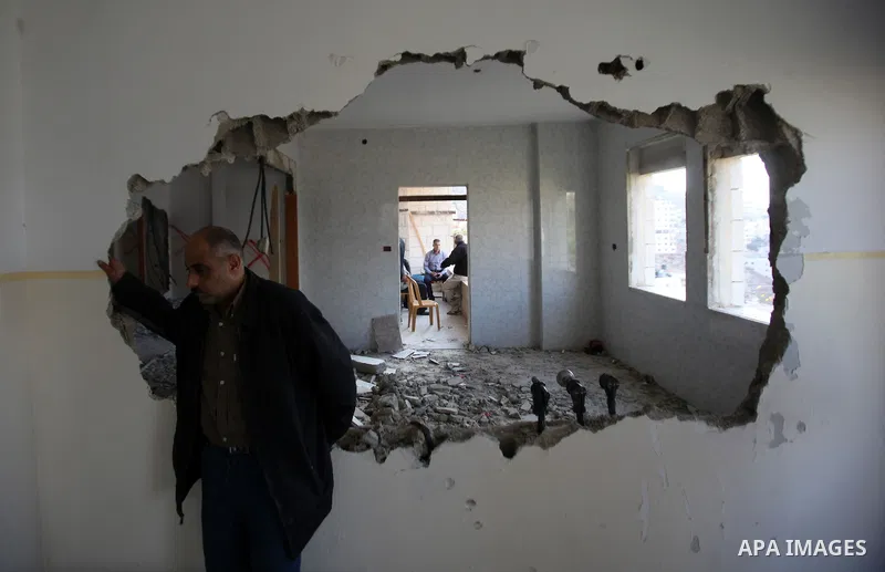 Palestinians check the house of Amjad Aliwi, a man accused of taking part in the killing of a Jewish settler couple near the settlement of Itamar in October last year, after Israeli authorities demolished it on October 1...