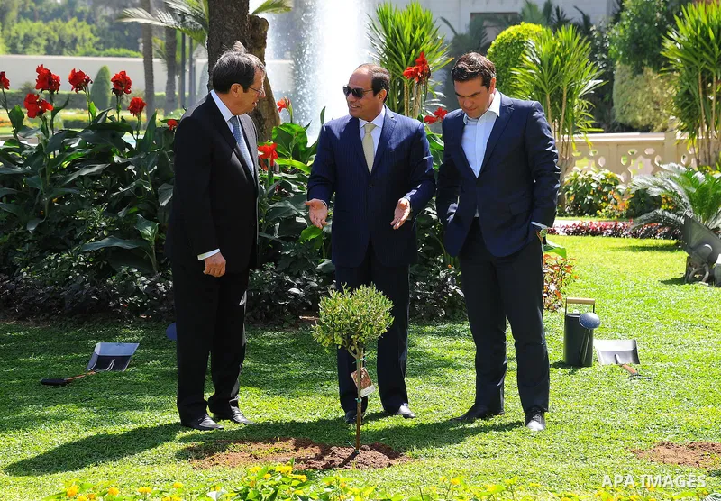 Egyptian President Abdel Fattah al-Sisi, Greek Prime Minister Alexis Tsipras and Greek Cyprian Leader Nicos Anastasiades, plant olive trees at Ittihadiya presidential palace garden in eastern Cairo, Egypt on October 11,...