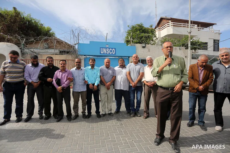 Palestinian members of the factions attend in a press conference, in front of the United Nations Special Coordinator (UNSCO) headquarters in Gaza city on October 12, 2016. Photo by Mohammed Asad