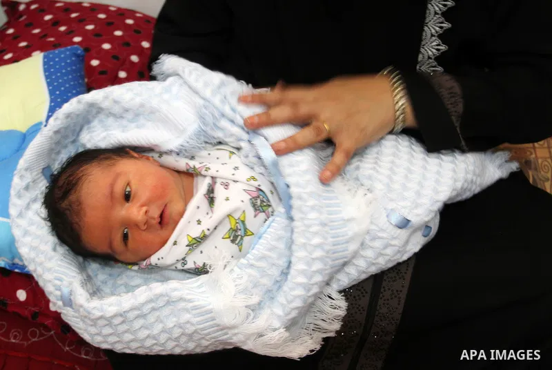 Tahany Shaath holds her three-day-old new-born son Waleed at their house in the southern Gaza Strip town of Rafah on October 12, 2016. The two millionth person has been born in Gaza, with the birth Waleed officially reco...