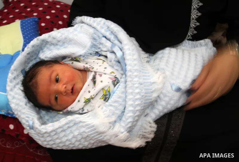 Tahany Shaath holds her three-day-old new-born son Waleed at their house in the southern Gaza Strip town of Rafah on October 12, 2016. The two millionth person has been born in Gaza, with the birth Waleed officially reco...