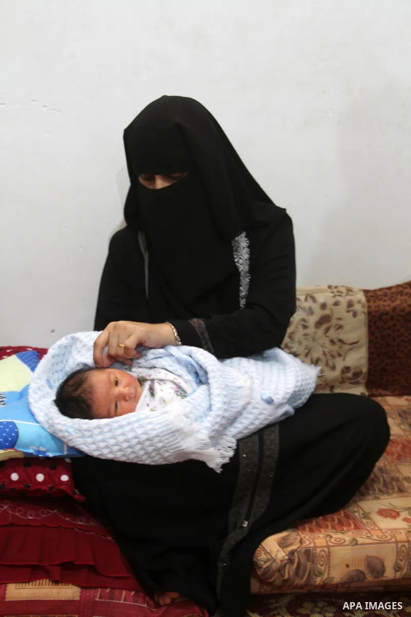 Tahany Shaath holds her three-day-old new-born son Waleed at their house in the southern Gaza Strip town of Rafah on October 12, 2016. The two millionth person has been born in Gaza, with the birth Waleed officially reco...