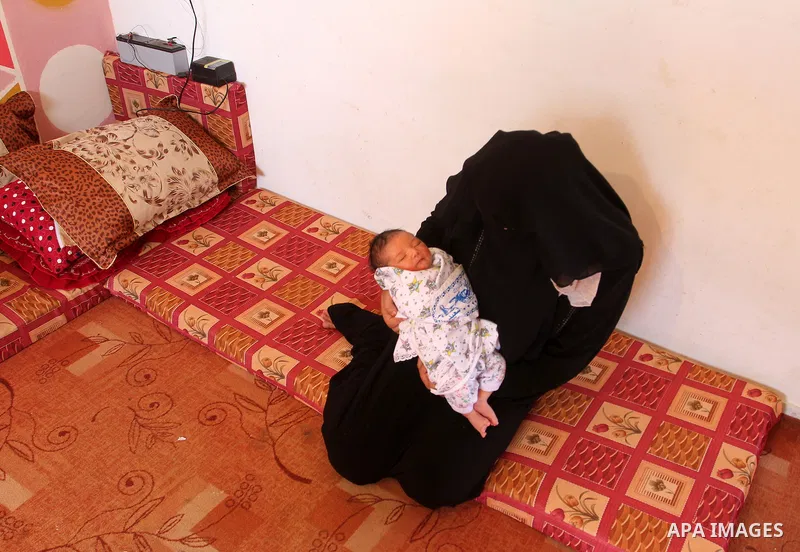 Tahany Shaath holds her three-day-old new-born son Waleed at their house in the southern Gaza Strip town of Rafah on October 12, 2016. The two millionth person has been born in Gaza, with the birth Waleed officially reco...