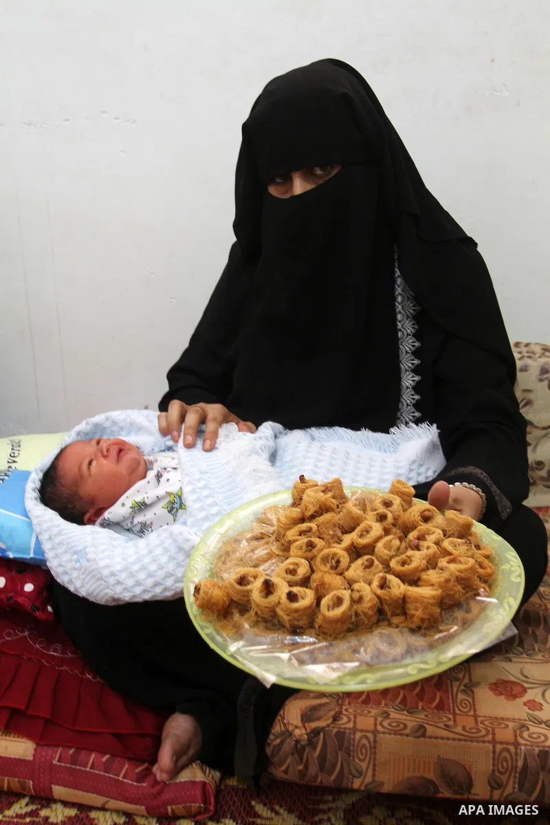 Tahany Shaath holds her three-day-old new-born son Waleed at their house in the southern Gaza Strip town of Rafah on October 12, 2016. The two millionth person has been born in Gaza, with the birth Waleed officially reco...
