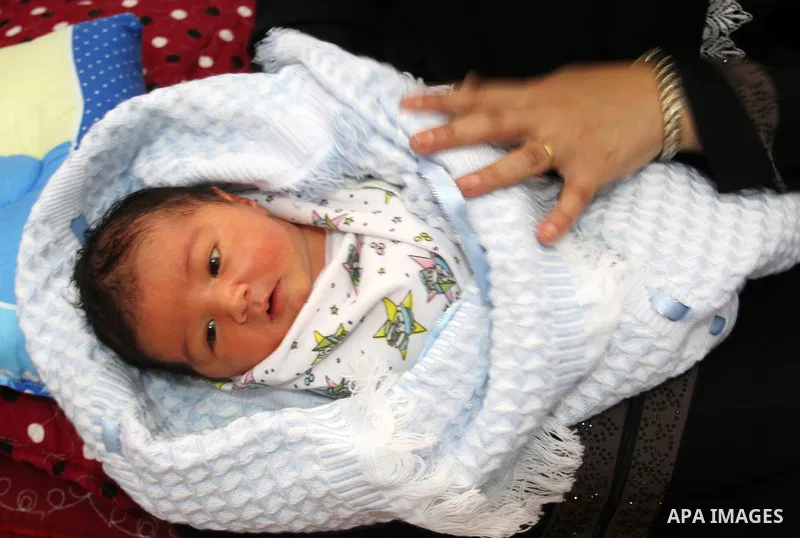 Three-day old new-born Waleed lies wraps in blankets at his family's home in the southern Gaza Strip town of Rafah on October 12, 2016. The two millionth person has been born in Gaza, with the birth Waleed officially rec...