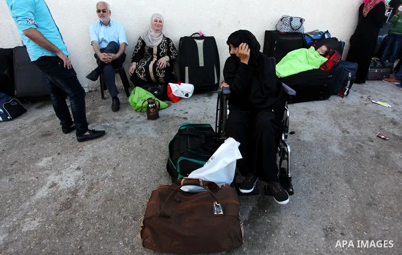 Palestinians wait for travel permits to cross into Egypt through the Rafah border crossing on October 15, 2016 in the southern Gaza Strip. Egyptian authorities temporarily reopened the crossing both directions for two da...