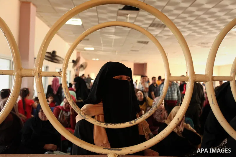 Palestinians wait for travel permits to cross into Egypt through the Rafah border crossing on October 15, 2016 in the southern Gaza Strip. Egyptian authorities temporarily reopened the crossing both directions for two da...