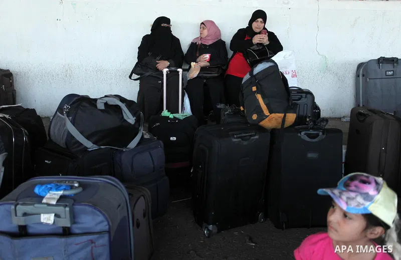 Palestinians wait for travel permits to cross into Egypt through the Rafah border crossing on October 15, 2016 in the southern Gaza Strip. Egyptian authorities temporarily reopened the crossing both directions for two da...