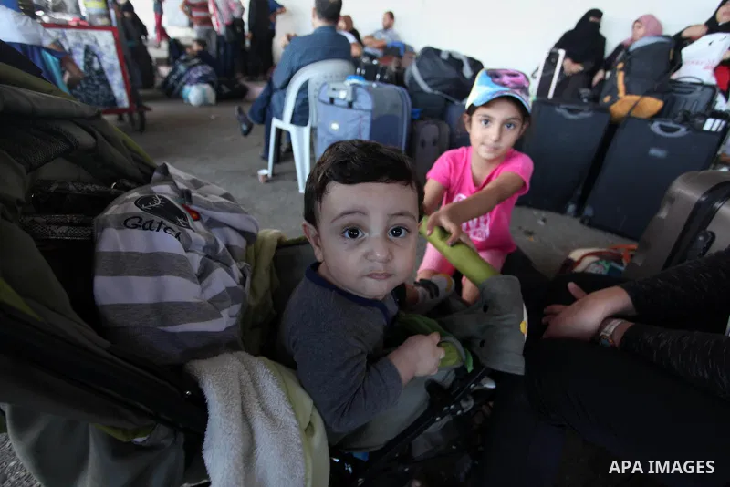 Palestinians wait for travel permits to cross into Egypt through the Rafah border crossing on October 15, 2016 in the southern Gaza Strip. Egyptian authorities temporarily reopened the crossing both directions for two da...