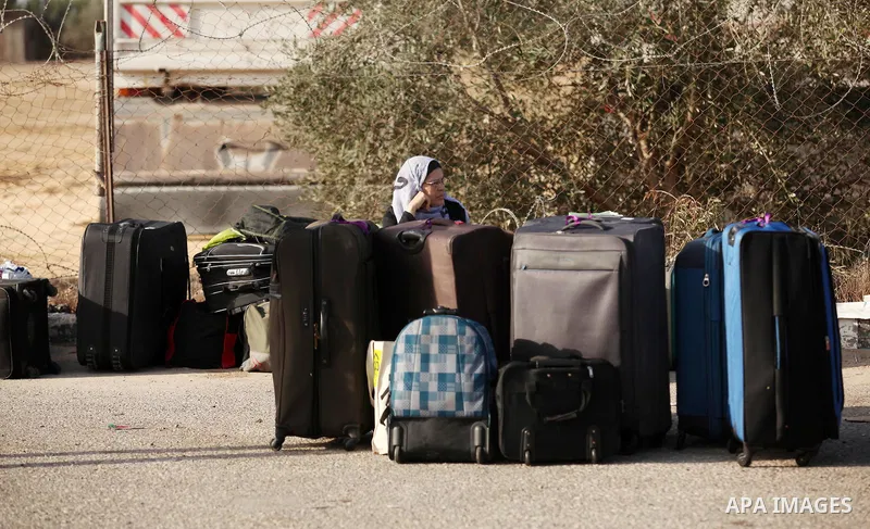Palestinians wait for travel permits to cross into Egypt through the Rafah border crossing on October 15, 2016 in the southern Gaza Strip. Egyptian authorities temporarily reopened the crossing both directions for two da...