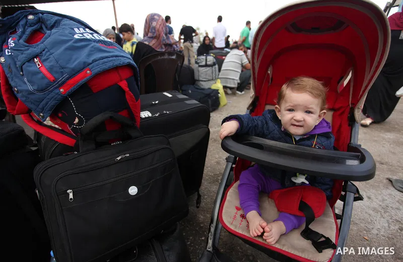 Palestinians wait for travel permits to cross into Egypt through the Rafah border crossing on October 15, 2016 in the southern Gaza Strip. Egyptian authorities temporarily reopened the crossing both directions for two da...