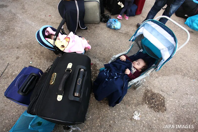 Palestinian childern sleep on a suitcase as they wait with their family for a travel permit to cross into Egypt through the Rafah border crossing on October 15, 2016 in the southern Gaza Strip. Egyptian authorities tempo...