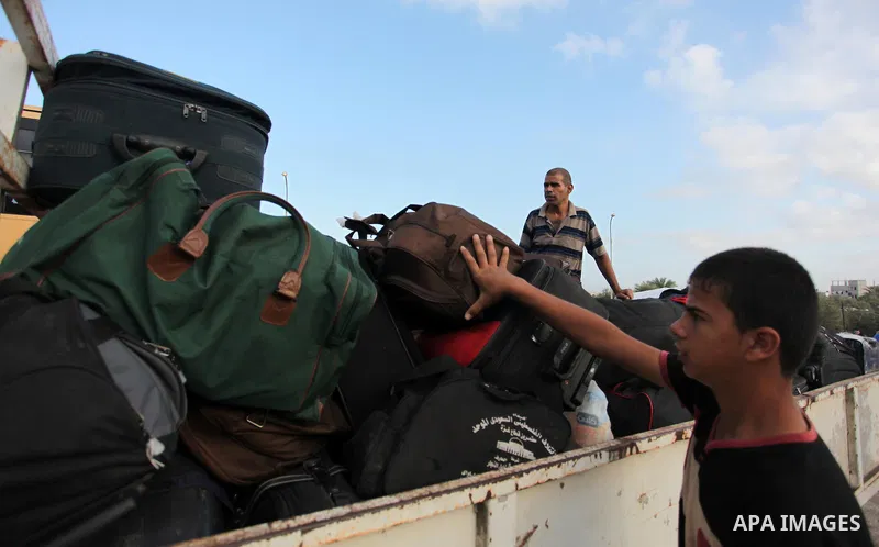 Palestinians wait for travel permits to cross into Egypt through the Rafah border crossing on October 15, 2016 in the southern Gaza Strip. Egyptian authorities temporarily reopened the crossing both directions for two da...