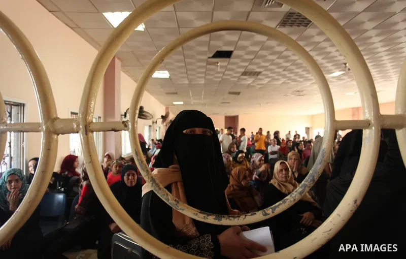 Palestinians wait for travel permits to cross into Egypt through the Rafah border crossing on October 15, 2016 in the southern Gaza Strip. Egyptian authorities temporarily reopened the crossing both directions for two da...