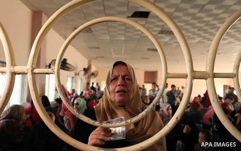 Palestinians wait for travel permits to cross into Egypt through the Rafah border crossing on October 15, 2016 in the southern Gaza Strip. Egyptian authorities temporarily reopened the crossing both directions for two da...