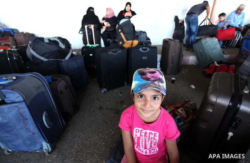 Palestinians wait for travel permits to cross into Egypt through the Rafah border crossing on October 15, 2016 in the southern Gaza Strip. Egyptian authorities temporarily reopened the crossing both directions for two da...