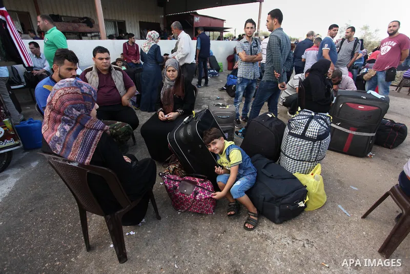 Palestinians wait for travel permits to cross into Egypt through the Rafah border crossing on October 15, 2016 in the southern Gaza Strip. Egyptian authorities temporarily reopened the crossing both directions for two da...