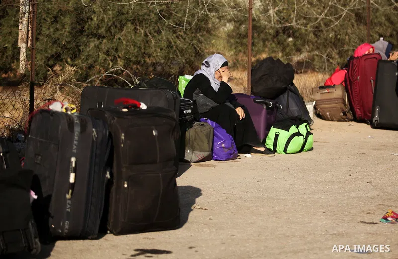 Palestinians wait for travel permits to cross into Egypt through the Rafah border crossing on October 15, 2016 in the southern Gaza Strip. Egyptian authorities temporarily reopened the crossing both directions for two da...