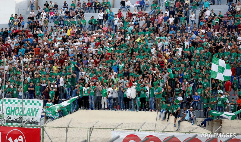 Fans attend the final match of the Palestinian Cup (Abu Ammar Cup) between Shabab Hebron players and Ozlan south (Zahryah) players, in the West Bank city of Hebron, on October 15, 2016. Photo by Wisam Hashlamoun