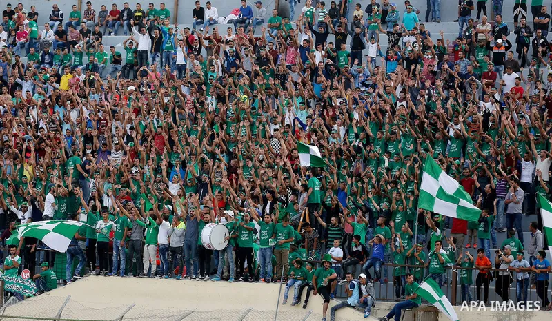 Fans attend the final match of the Palestinian Cup (Abu Ammar Cup) between Shabab Hebron players and Ozlan south (Zahryah) players, in the West Bank city of Hebron, on October 15, 2016. Photo by Wisam Hashlamoun