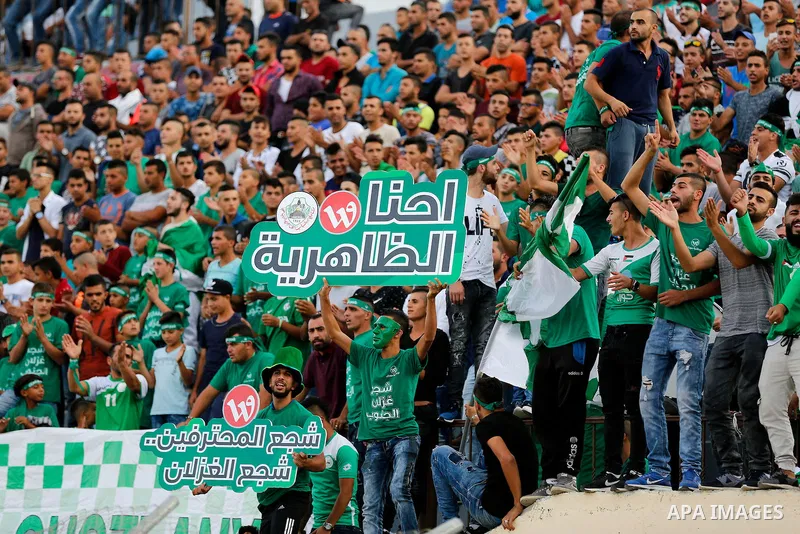 Fans attend the final match of the Palestinian Cup (Abu Ammar Cup) between Shabab Hebron players and Ozlan south (Zahryah) players, in the West Bank city of Hebron, on October 15, 2016. Photo by Wisam Hashlamoun