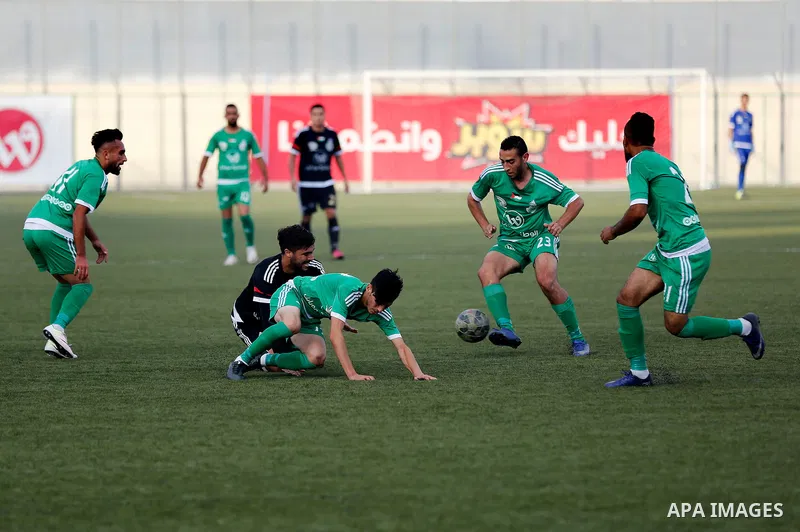 Shabab Hebron players and Ozlan south (Zahryah) players compete during the final match of the Palestinian Cup (Abu Ammar Cup), in the West Bank city of Hebron, on October 15, 2016. Photo by Wisam Hashlamoun