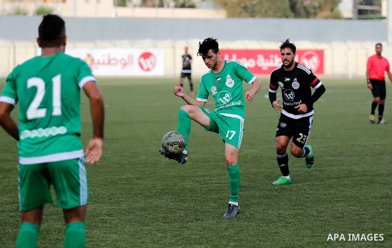 Shabab Hebron players and Ozlan south (Zahryah) players compete during the final match of the Palestinian Cup (Abu Ammar Cup), in the West Bank city of Hebron, on October 15, 2016. Photo by Wisam Hashlamoun