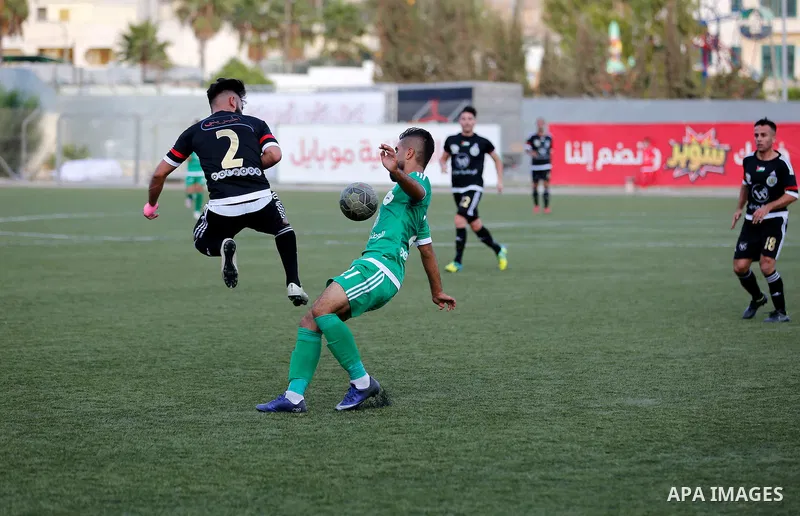 Shabab Hebron players and Ozlan south (Zahryah) players compete during the final match of the Palestinian Cup (Abu Ammar Cup), in the West Bank city of Hebron, on October 15, 2016. Photo by Wisam Hashlamoun