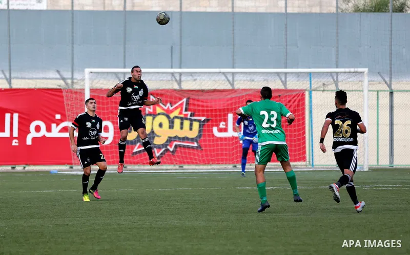 Shabab Hebron players and Ozlan south (Zahryah) players compete during the final match of the Palestinian Cup (Abu Ammar Cup), in the West Bank city of Hebron, on October 15, 2016. Photo by Wisam Hashlamoun