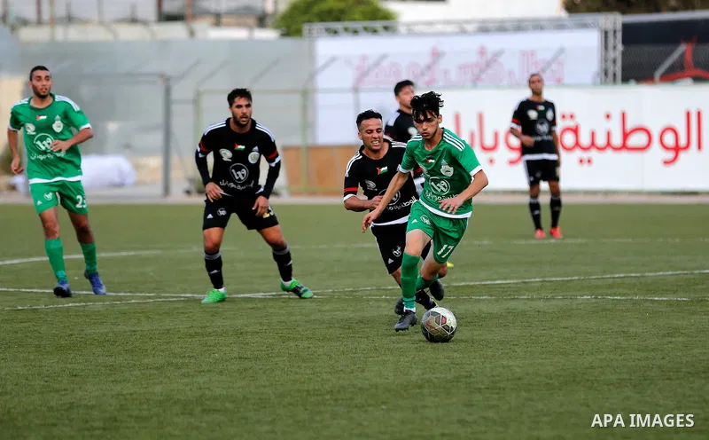 Shabab Hebron players and Ozlan south (Zahryah) players compete during the final match of the Palestinian Cup (Abu Ammar Cup), in the West Bank city of Hebron, on October 15, 2016. Photo by Wisam Hashlamoun