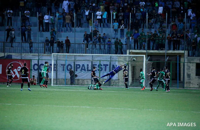 Shabab Hebron players and Ozlan south (Zahryah) players compete during the final match of the Palestinian Cup (Abu Ammar Cup), in the West Bank city of Hebron, on October 15, 2016. Photo by Wisam Hashlamoun