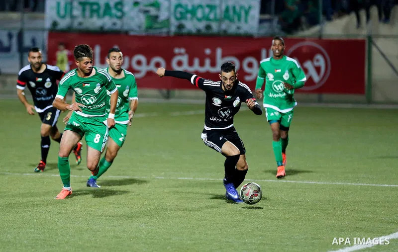 Shabab Hebron players and Ozlan south (Zahryah) players compete during the final match of the Palestinian Cup (Abu Ammar Cup), in the West Bank city of Hebron, on October 15, 2016. Photo by Wisam Hashlamoun