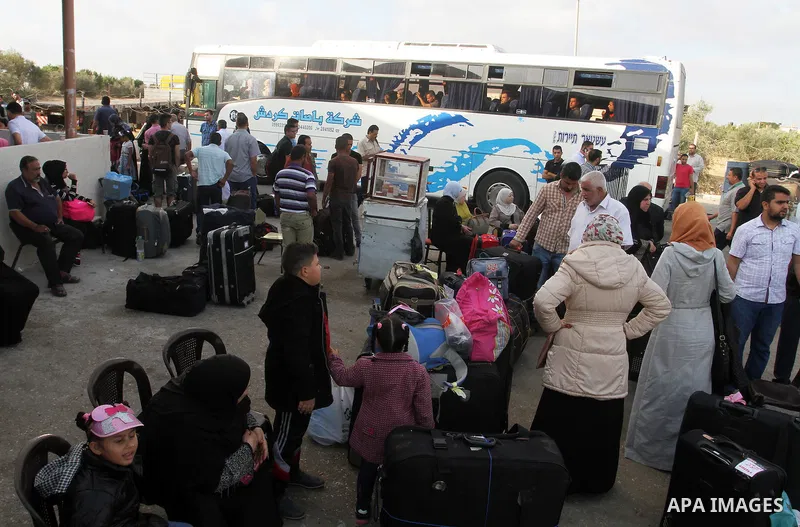 Palestinians wait for travel permits to cross into Egypt through the Rafah border crossing on October 16, 2016 in the southern Gaza Strip. Egyptian authorities temporarily reopened the crossing both directions for two da...