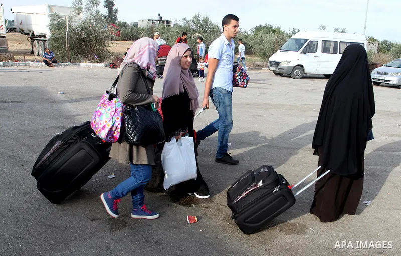 Palestinians wait for travel permits to cross into Egypt through the Rafah border crossing on October 16, 2016 in the southern Gaza Strip. Egyptian authorities temporarily reopened the crossing both directions for two da...