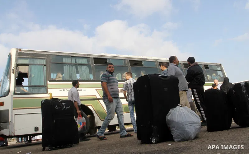 Palestinians wait for travel permits to cross into Egypt through the Rafah border crossing on October 16, 2016 in the southern Gaza Strip. Egyptian authorities temporarily reopened the crossing both directions for two da...