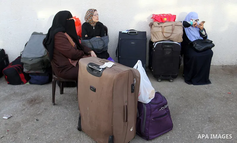 Palestinians wait for travel permits to cross into Egypt through the Rafah border crossing on October 16, 2016 in the southern Gaza Strip. Egyptian authorities temporarily reopened the crossing both directions for two da...