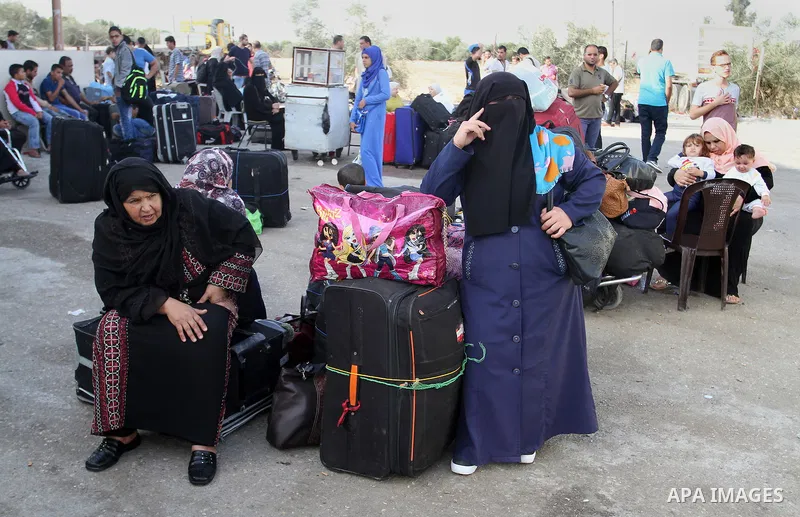 Palestinians wait for travel permits to cross into Egypt through the Rafah border crossing on October 16, 2016 in the southern Gaza Strip. Egyptian authorities temporarily reopened the crossing both directions for two da...