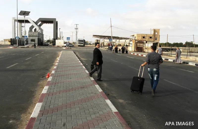 Palestinians wait for travel permits to cross into Egypt through the Rafah border crossing on October 16, 2016 in the southern Gaza Strip. Egyptian authorities temporarily reopened the crossing both directions for two da...