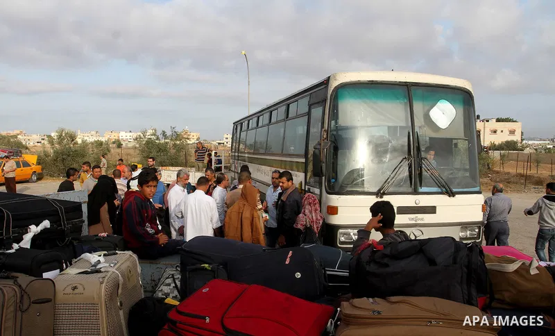 Palestinians wait for travel permits to cross into Egypt through the Rafah border crossing on October 16, 2016 in the southern Gaza Strip. Egyptian authorities temporarily reopened the crossing both directions for two da...