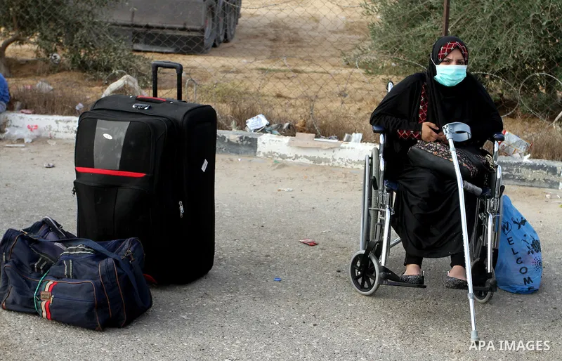 Palestinians wait for travel permits to cross into Egypt through the Rafah border crossing on October 16, 2016 in the southern Gaza Strip. Egyptian authorities temporarily reopened the crossing both directions for two da...