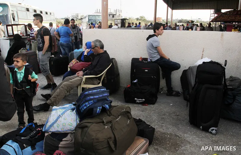 Palestinians wait for travel permits to cross into Egypt through the Rafah border crossing on October 16, 2016 in the southern Gaza Strip. Egyptian authorities temporarily reopened the crossing both directions for two da...